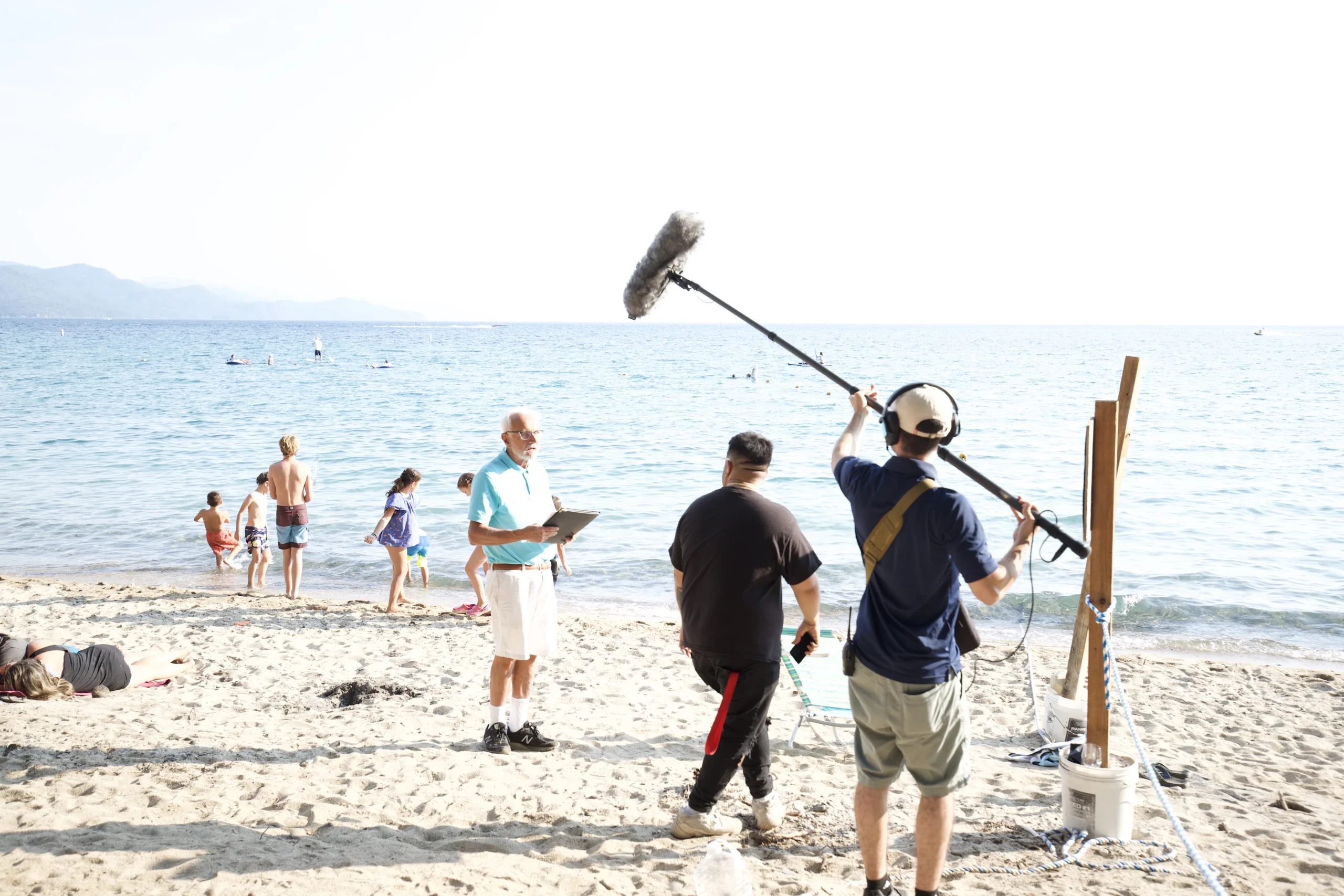 Fr. Mike Russo filming a conversation on the shore of Lake Tahoe